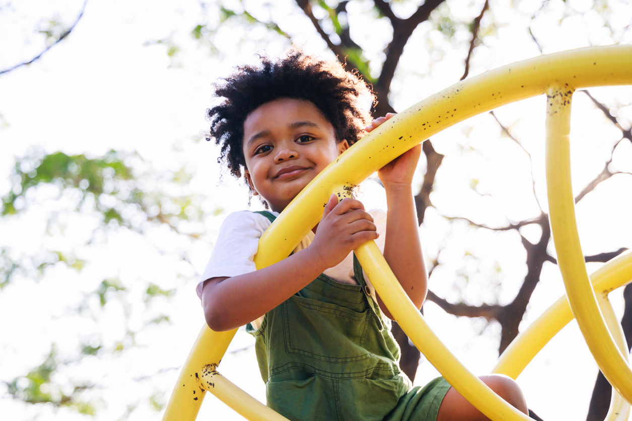 Little boy on a yellow climbing structure