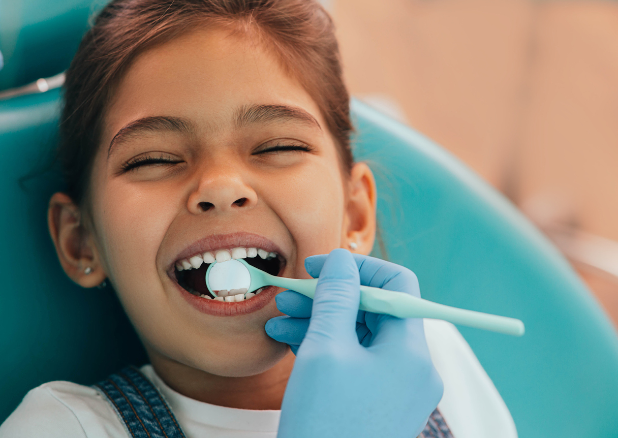 Cute girl in dentist's chair getting a free dental screening at Olympia's Hands On Children's Museum