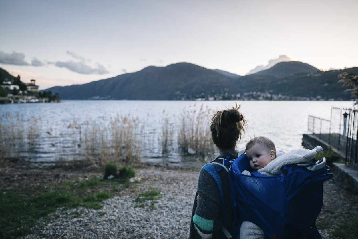 Mom carrying a baby in backpack by a lake is a wonderful thing to do with a baby in Seattle