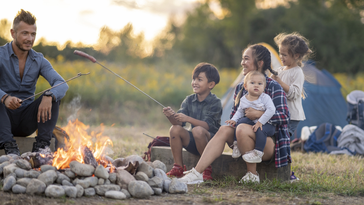 family camping with young children and sitting around a camp fire