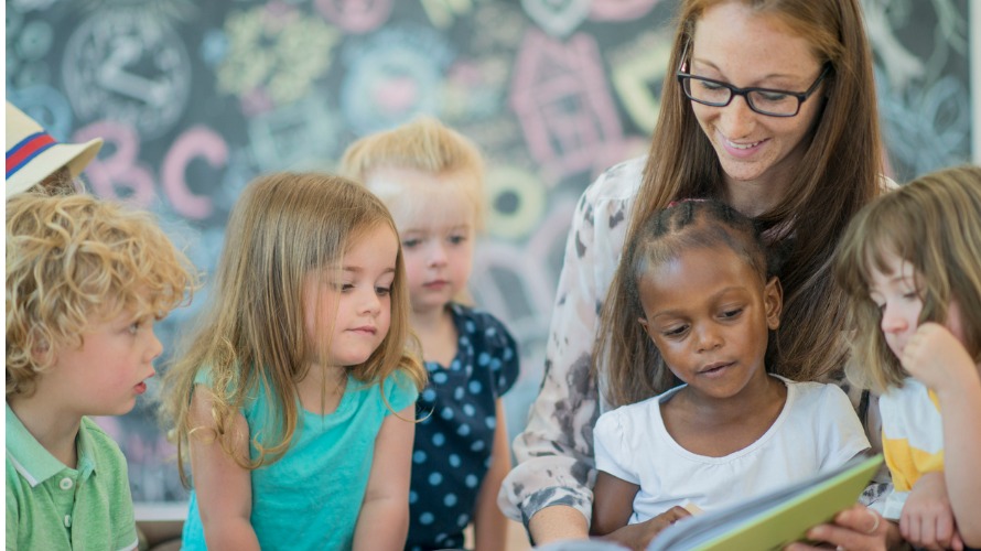 Woman reading to preschoolers