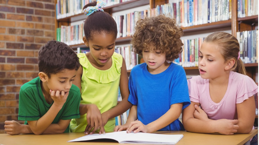 Students reading a book together