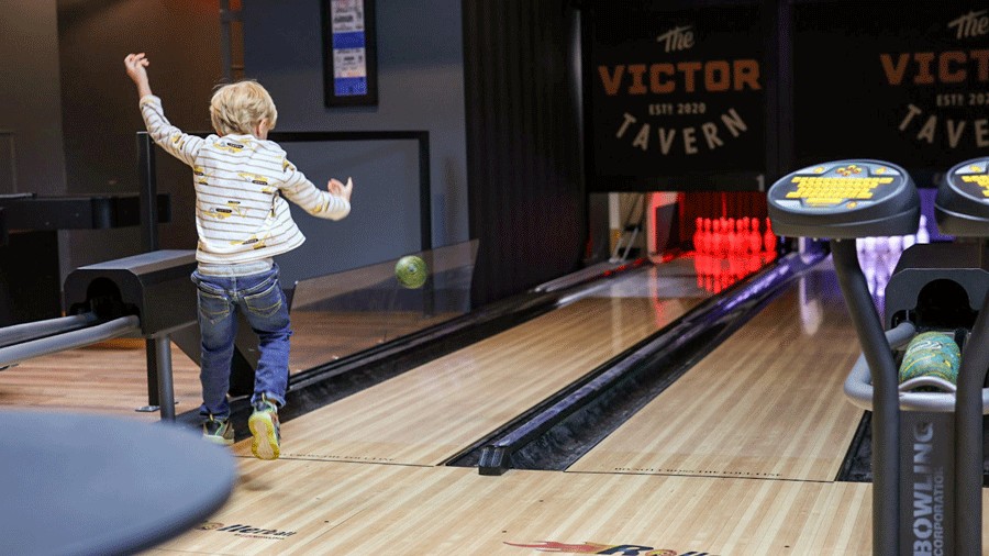 young boy bowing at The Victor Tavern in Edmonds, a family-friendly restaurant with bowling lanes
