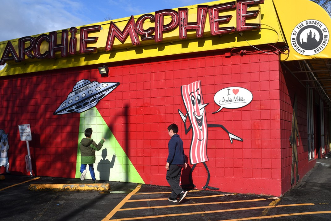 Two elementary age boys stand next to Seattle's Archie McPhee store which celebrates its 40th anniversary in 2023