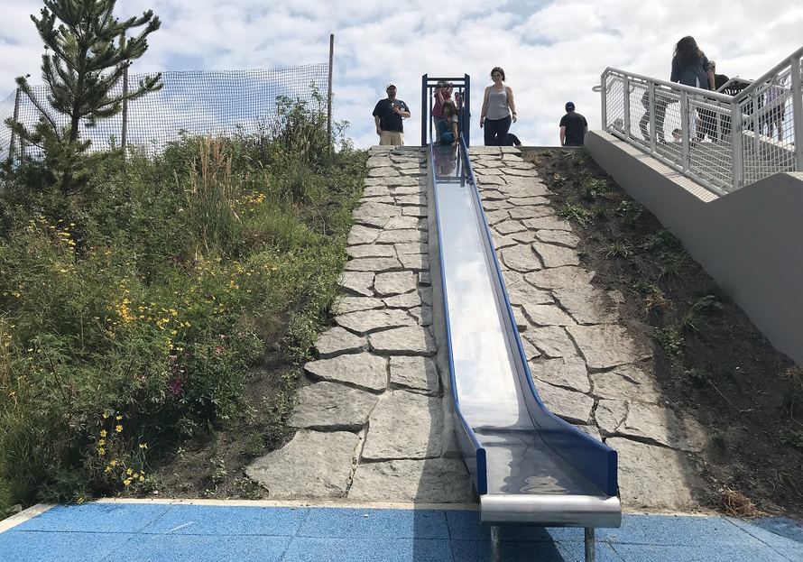 Kids at the top of a large slide