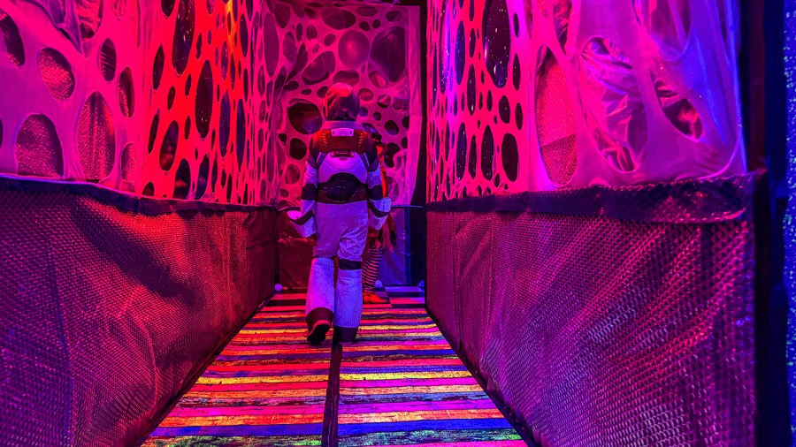 Kid walking through tunnel at Cosmic Carnival Seattle, a new Halloween experience