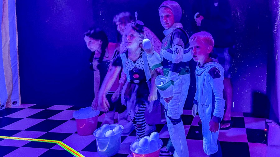 Kids playing carnival games at Cosmic Carnival, a family-friendly Seattle activity
