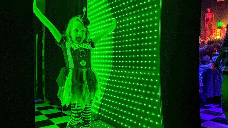 Young girl in light tunnel at Cosmic Carnival, a family-friendly Seattle activity