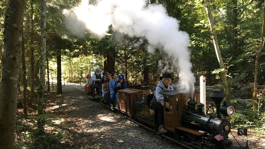 A mini steam locomotive rides the track for Kitsap Live Steamers, a Seattle-area train adventure