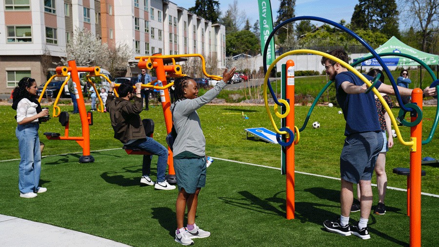 adults working out at a new Seattle park with fitness equipment