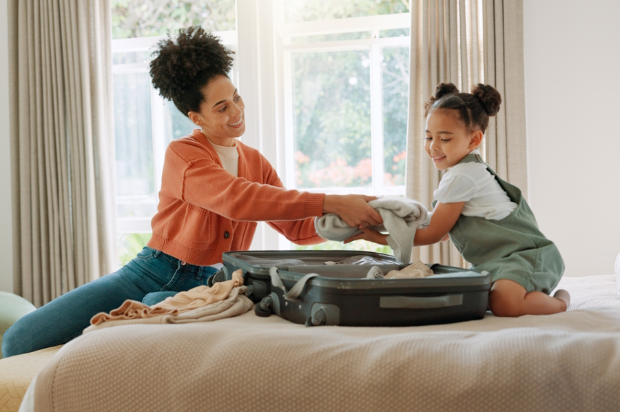 mom and daughter packing for a trip