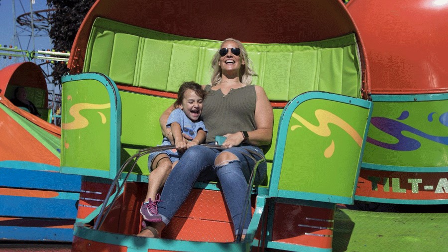 Mom and daughter ride rides at the Washington State Fair in Puyallup