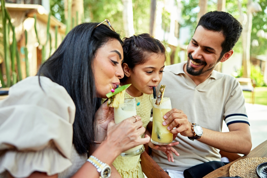 family enjoying a virgin pina colada