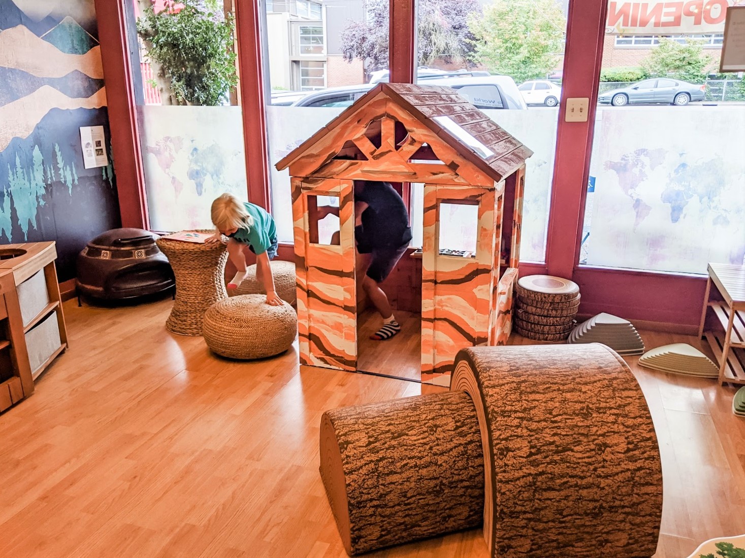 Kids playing in a playhouse inside new Seattle-area indoor play space Child Wonder the World inspiring global learning