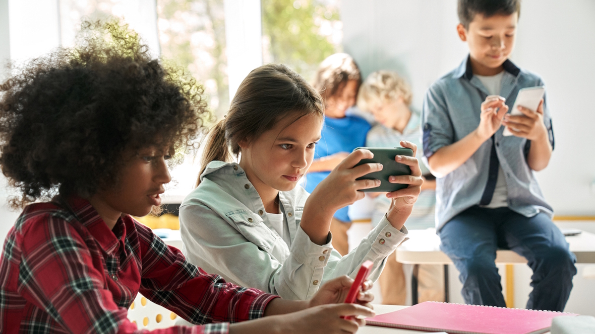 kids in a classroom not talking or doing work looking at their cell phones