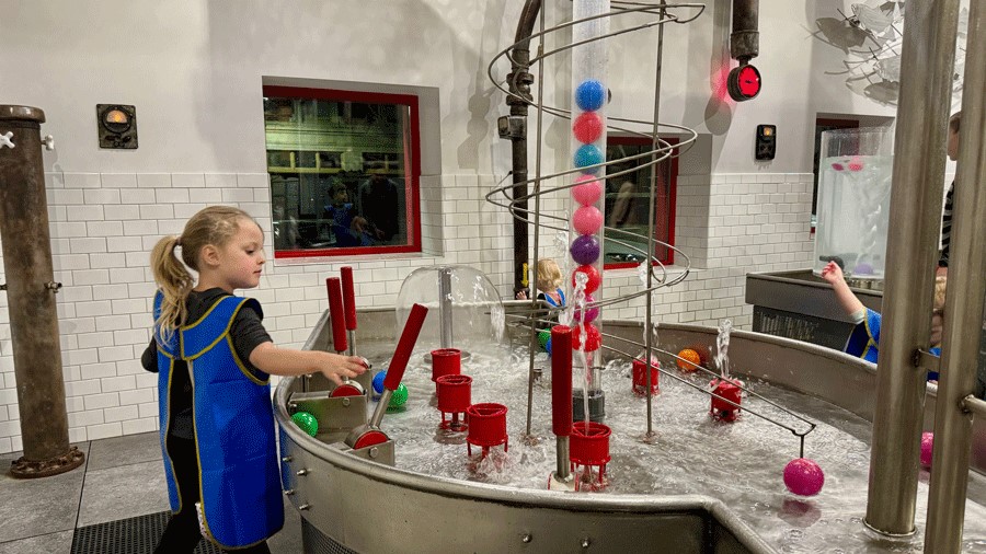Young girl at Imagine Children’s Museum in Everett plays with water at the Water Works exhibit