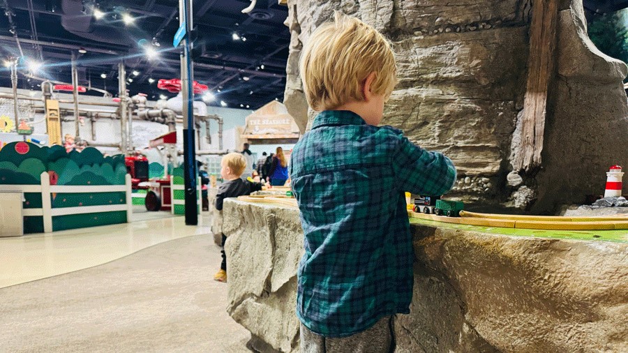 Young boy plays with trains at Imagine Children’s Museum in Everett