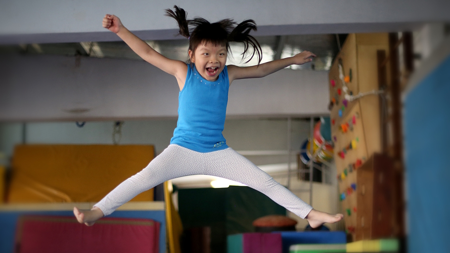Little girl jumping in a gymnastics room cheap things to do in Seattle