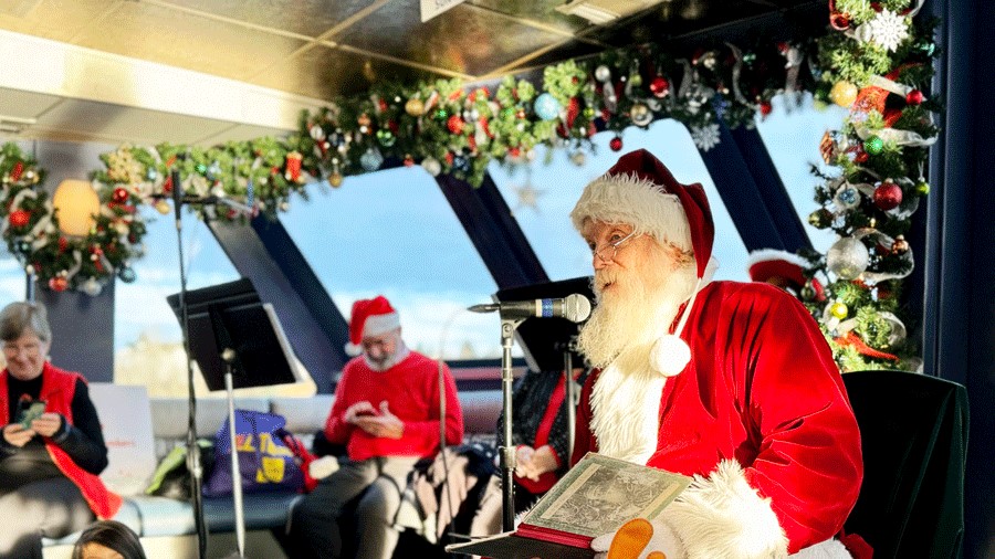 Santa reading The Night Before Christmas to young kids on the Argosy Christmas Ship