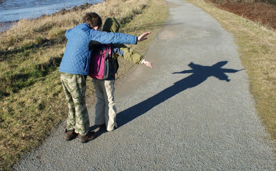 kids make a shadow on a spring hike near seattle at Padilla bay