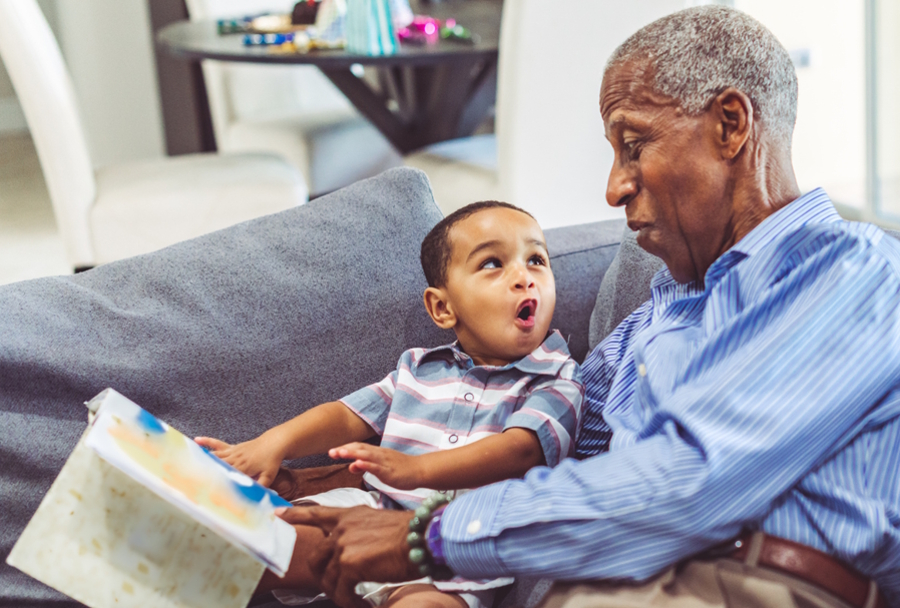 grandpa and grandson reading a book together 