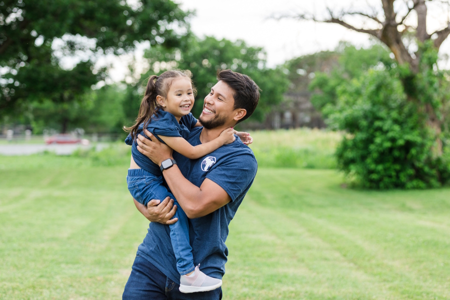 uncle and niece at a park playing and having fun together