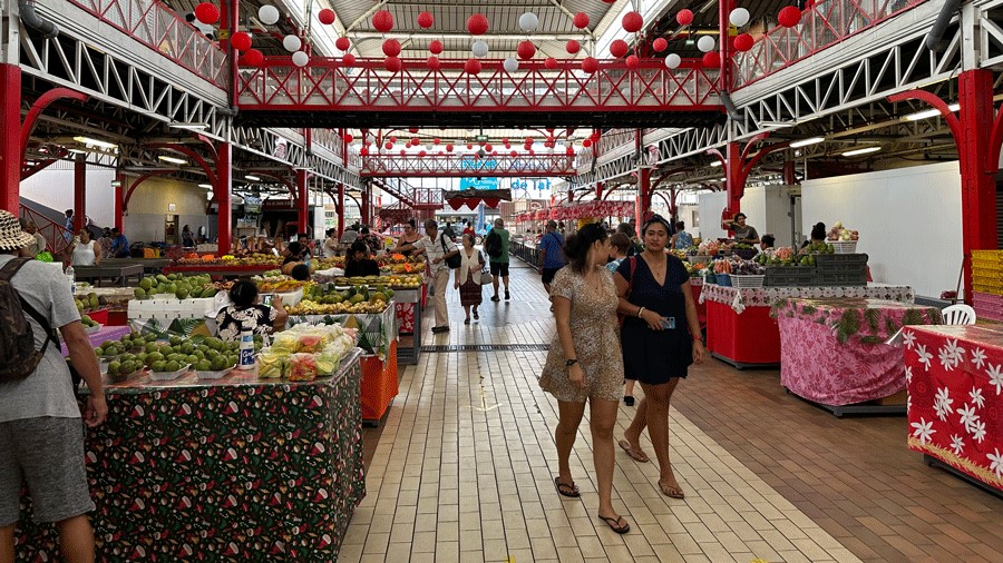 People shop at the public market in Tahit
