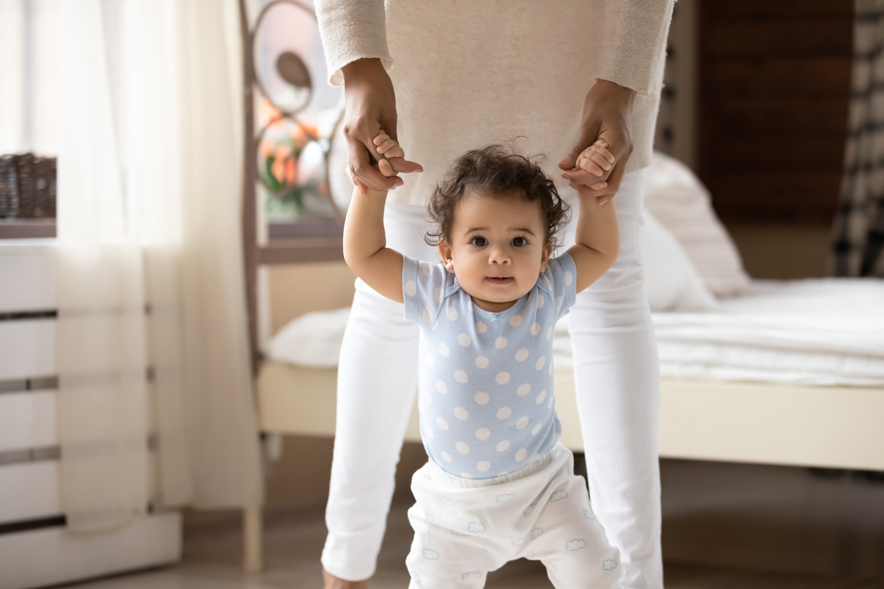 Cute African American toddler girl taking first steps