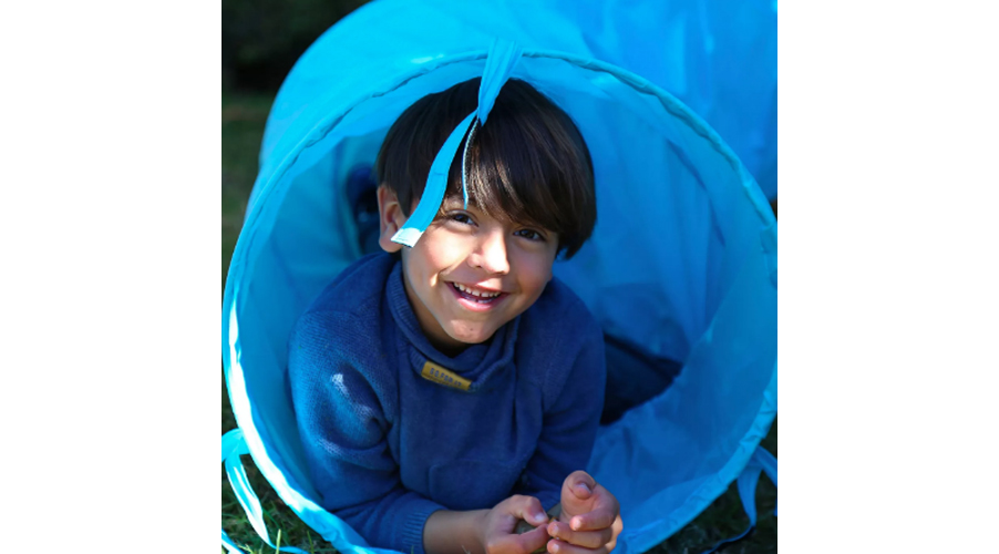 boy in a blue tunnel