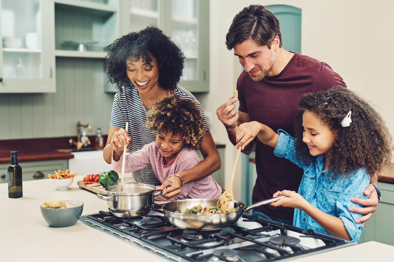 parents and two kids cooking together