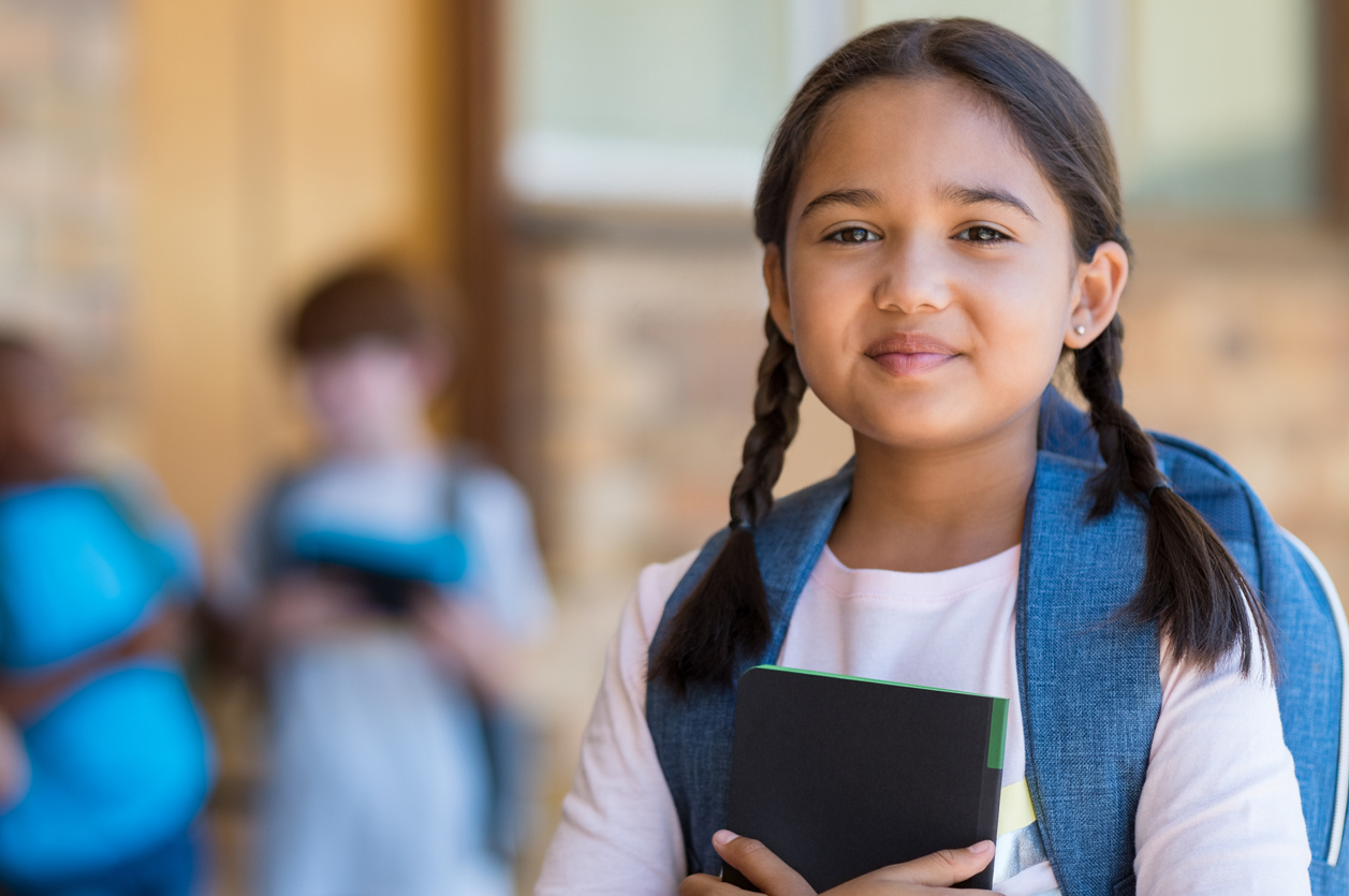 confident girl with a small smile looking at the camera