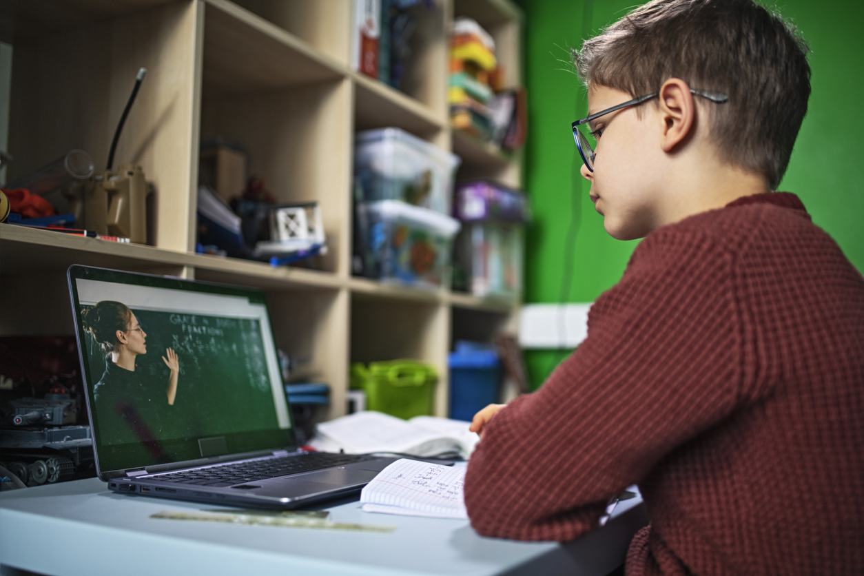 Young student attends school by video conference