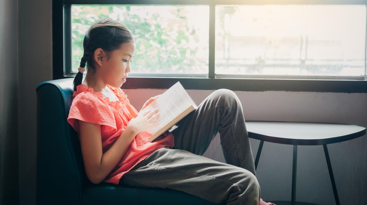 girl reading by a window