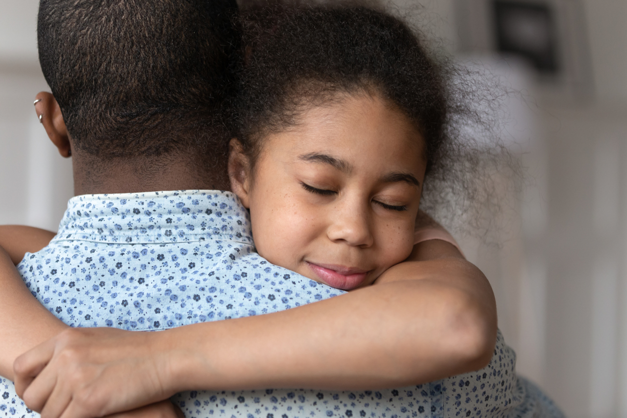 daughter hugging her dad for comfort