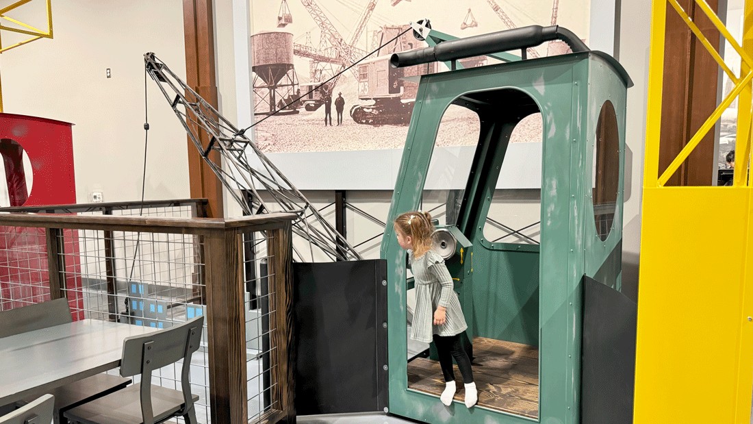 young preschooler operating a play crane at nick's magnificent