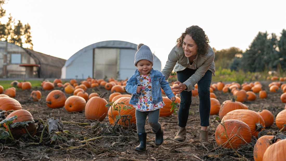 mom and young child exploring a pumpkin patch during a fall outing near Seattle