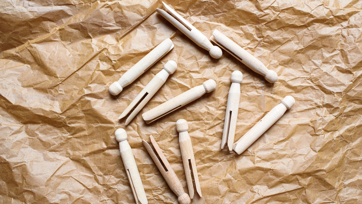 clothespins lying on a brown paper background