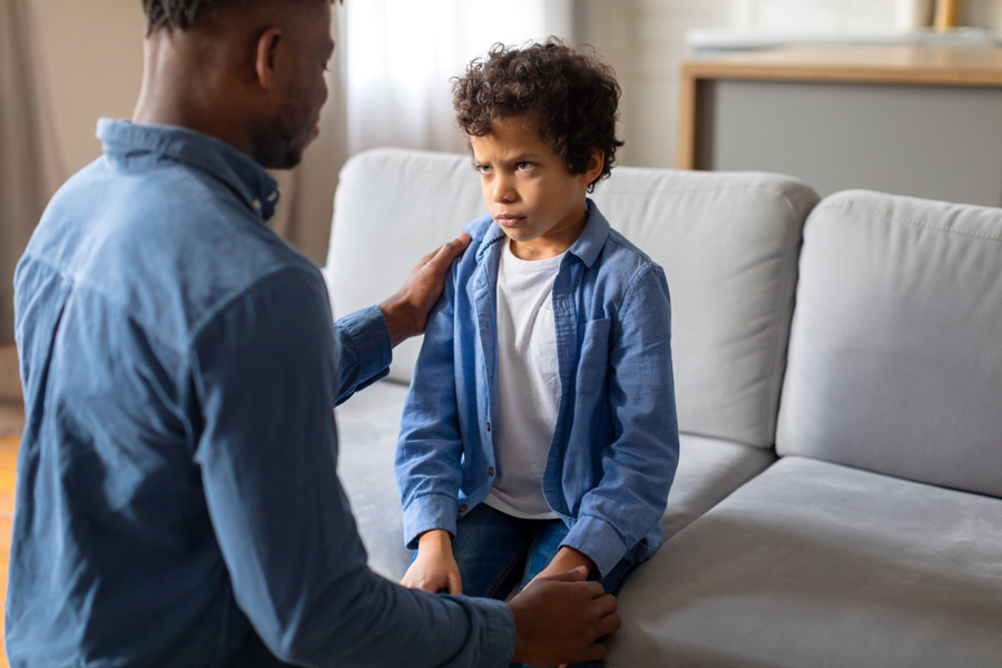 Dad and son talking while son is upset