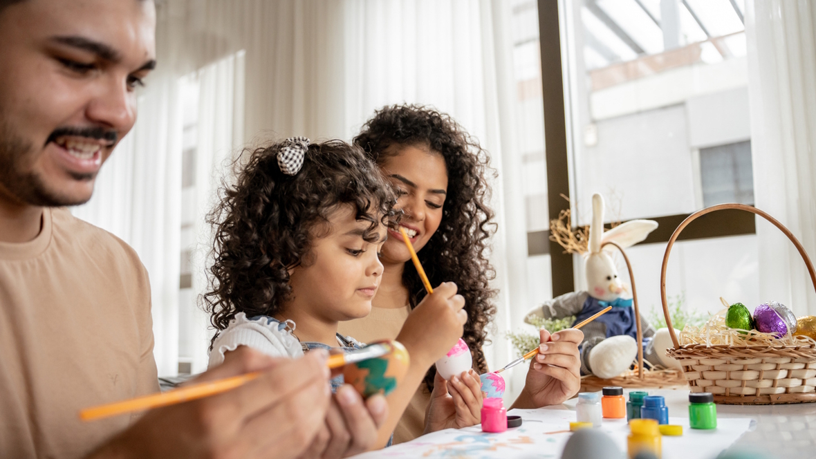 family painting Easter eggs together