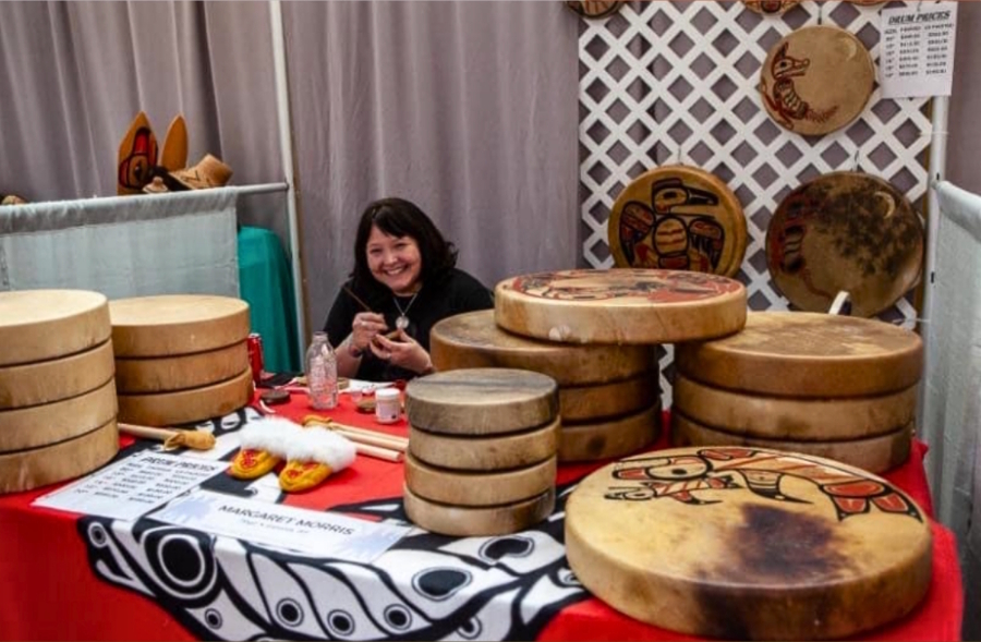 woman selling art at the Native Art Market