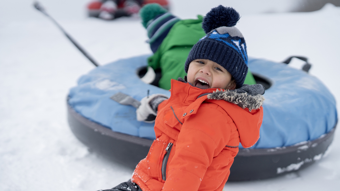kid in a tube in the snow