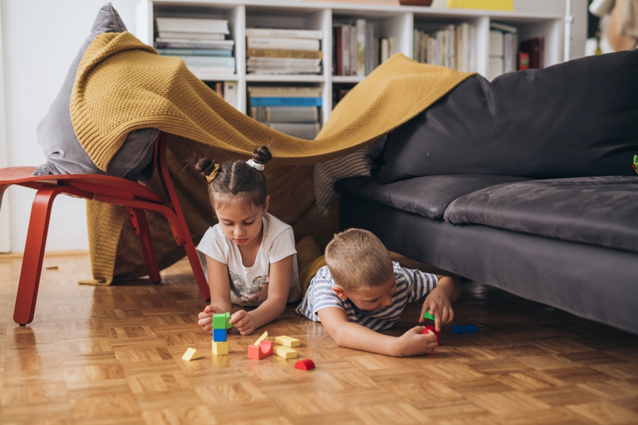 kids in a living room fort