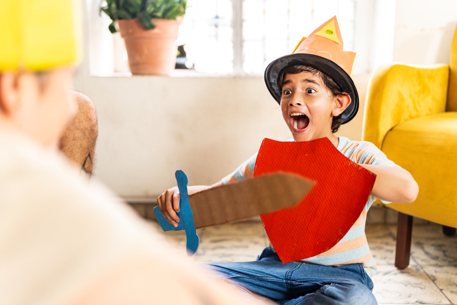child wearing a costume acting out a play at home