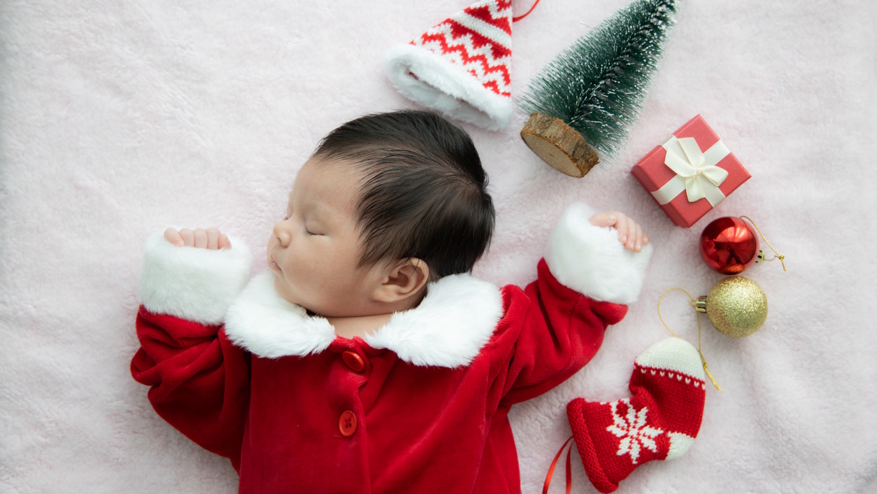 sleeping baby with holiday decorations