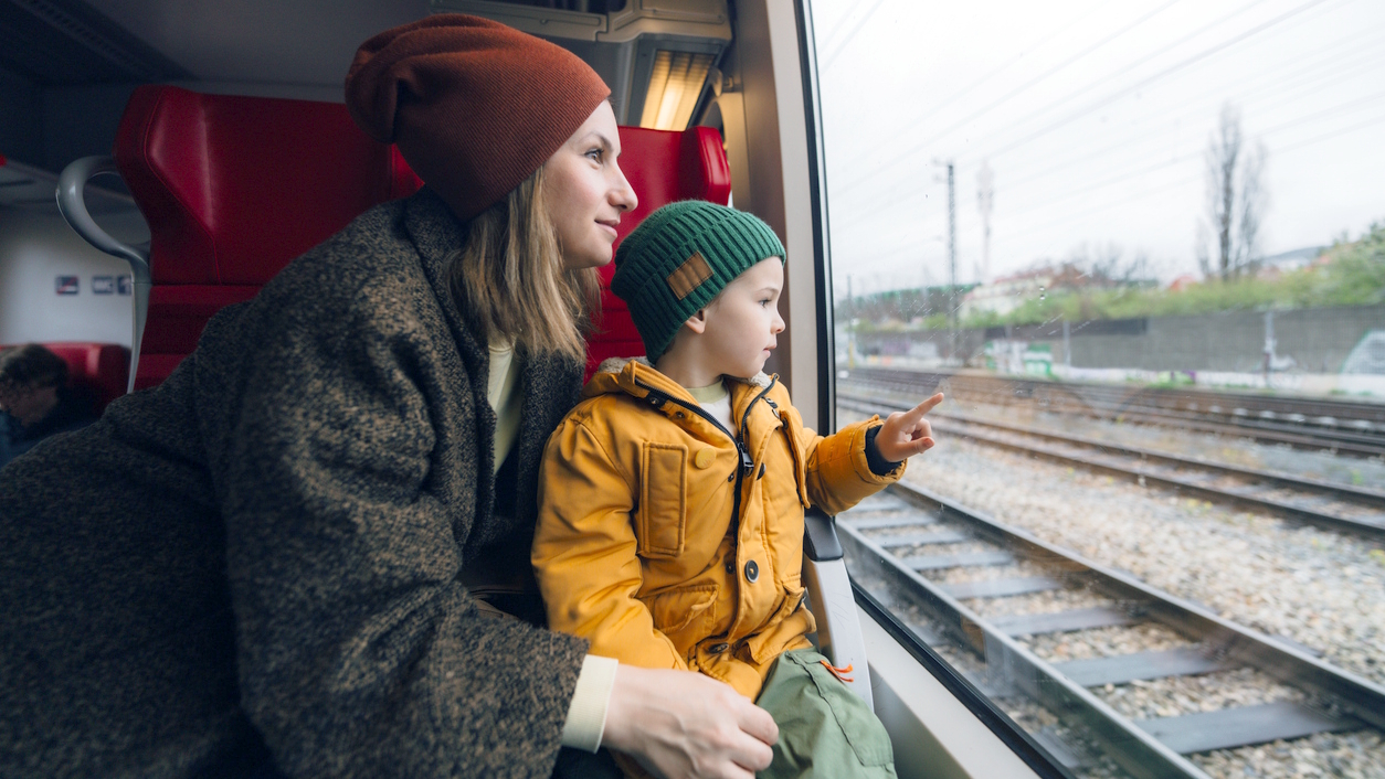 mom and child on a train traveling together