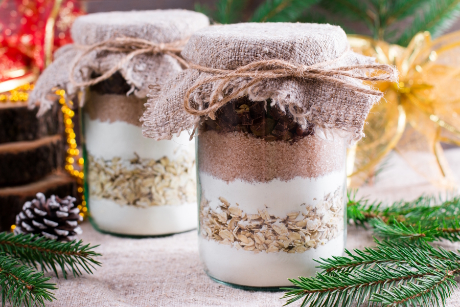 glass jars filled with the ingrediencies for cookies