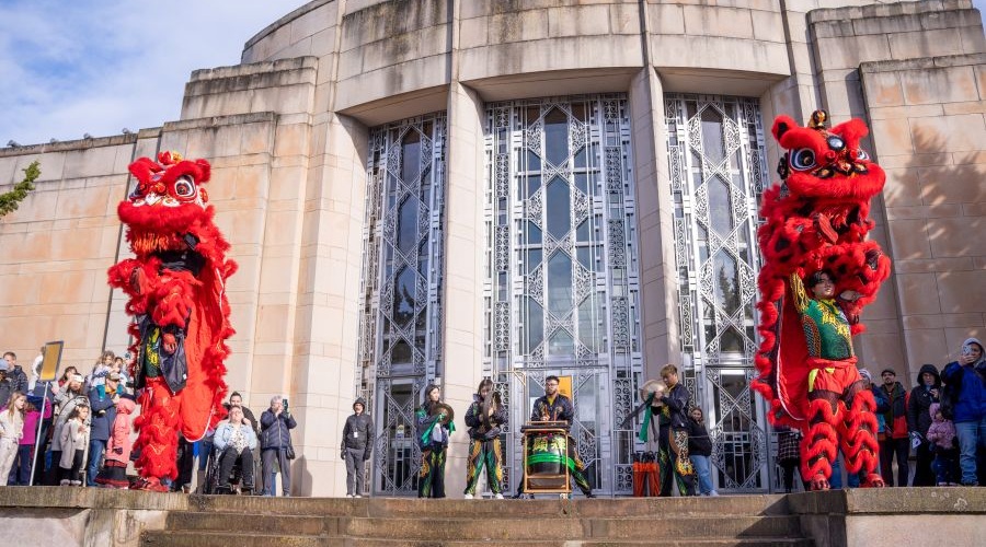 Dragon dancers and drummers perform in from of the Seattle Asian Art Museum. 