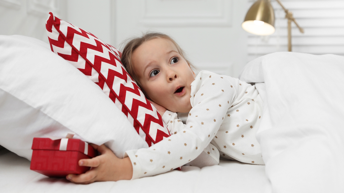 girl finding a present under her pillow tooth fairy