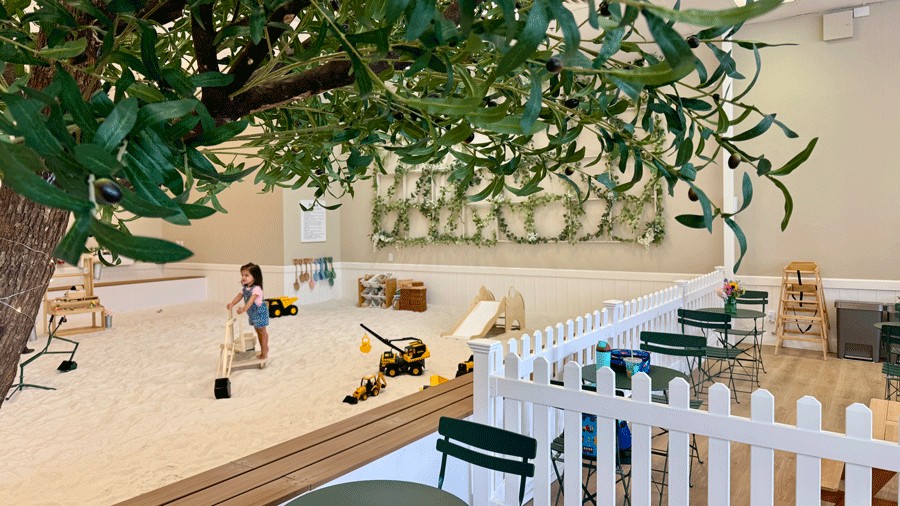 sight lines into the sandbox at The Sand Garden with a young girl playing