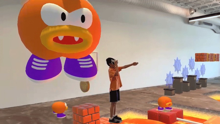 young boy pointing with a giant video game character behind him